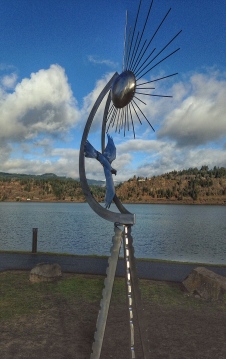 More brushed aluminum with a figurative sun and a river bird. Artist: Jesse Swickard